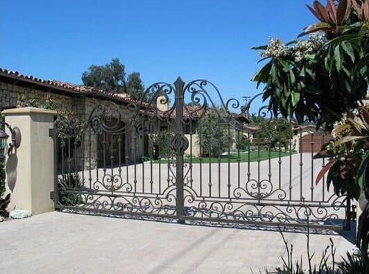 A wrought iron gate in front of a house