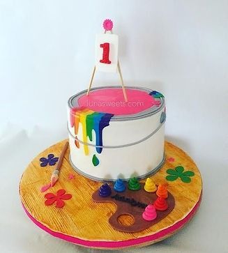 A cake that looks like a bucket of paint with the number 1 on it