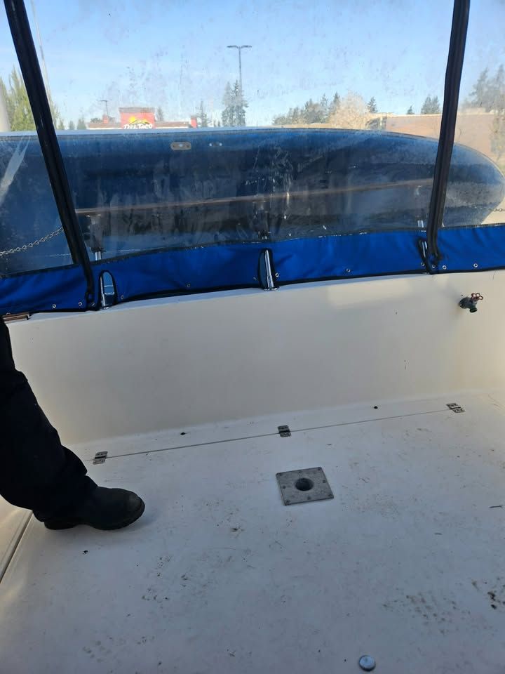 A person is standing on the deck of a boat.