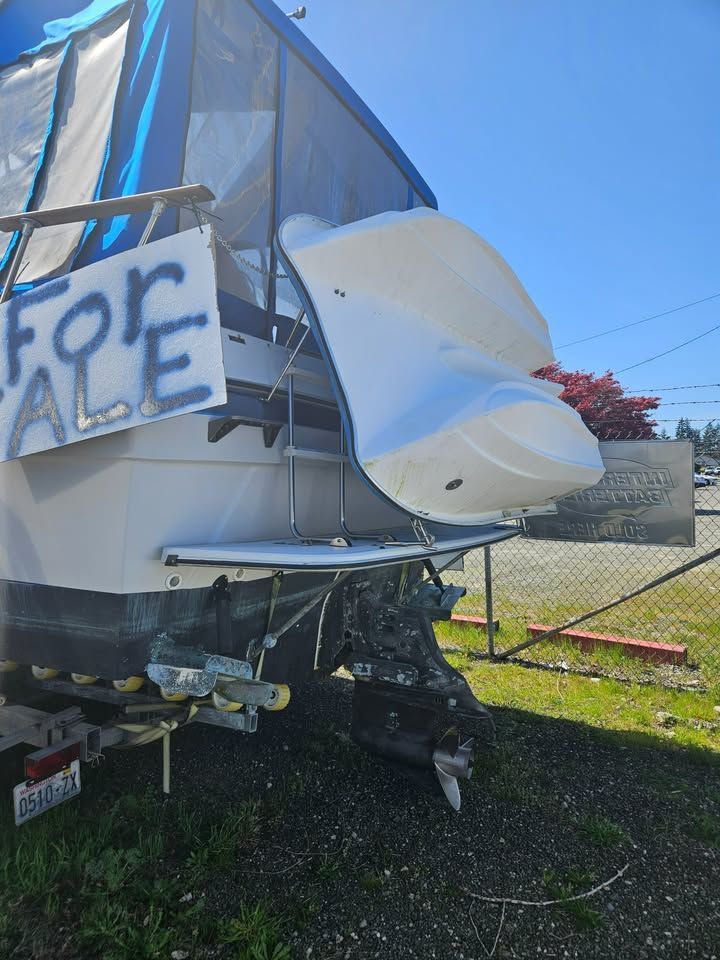 A boat with a for sale sign on it.