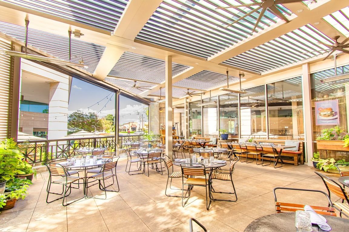 There are many tables and chairs in the restaurant.