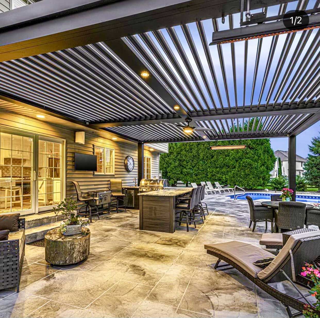 A patio with a pergola and a swimming pool in the background
