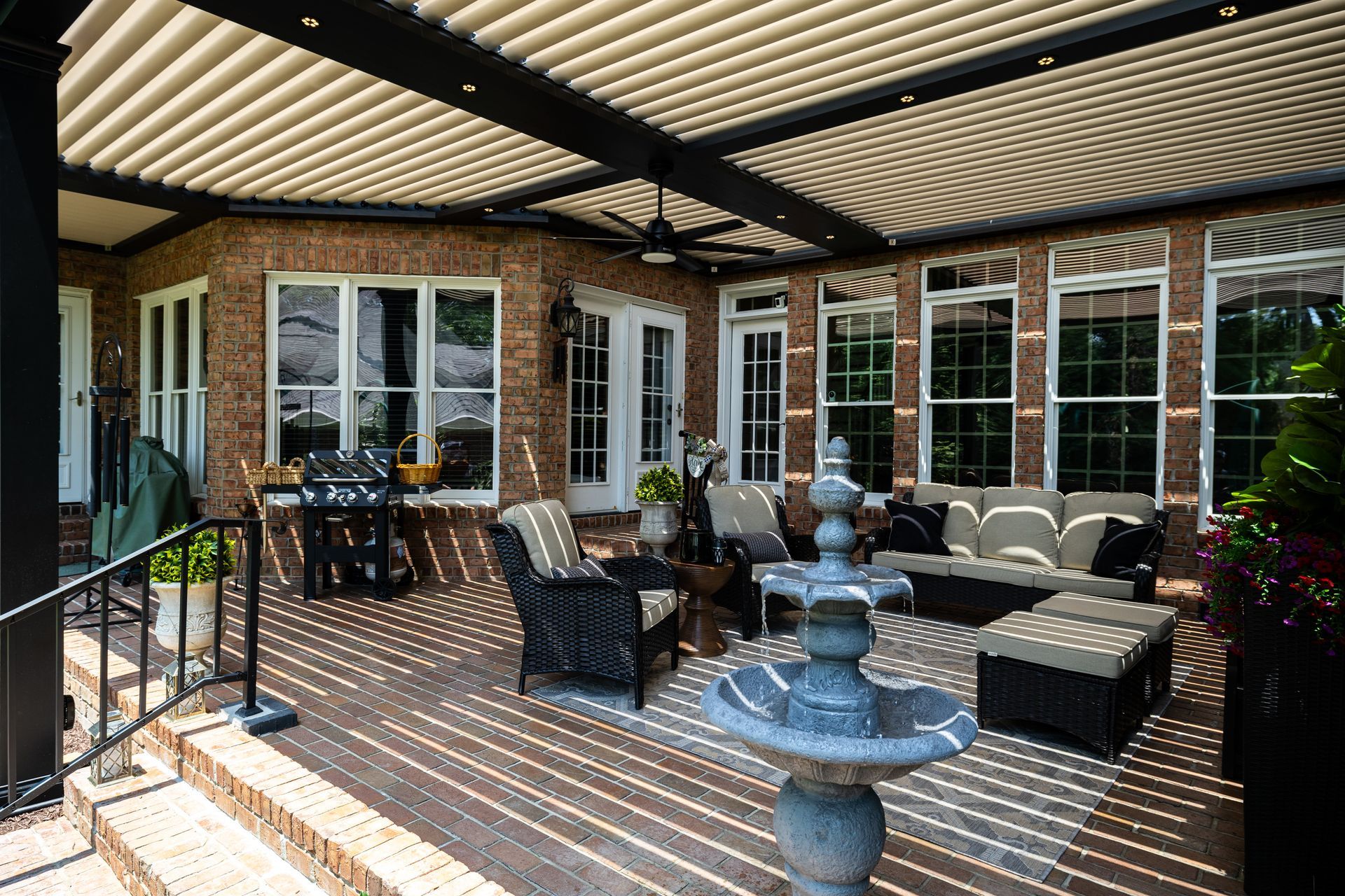 There is a fountain in the middle of the patio.