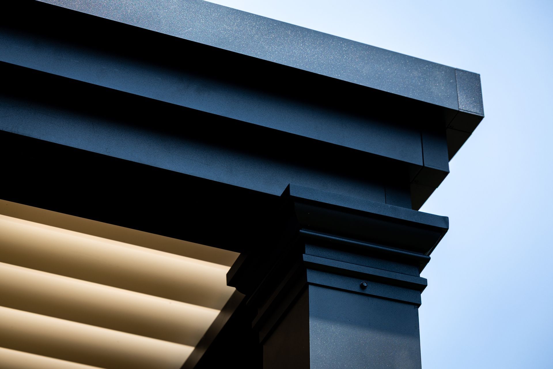 A close up of the roof of a building with a blue sky in the background