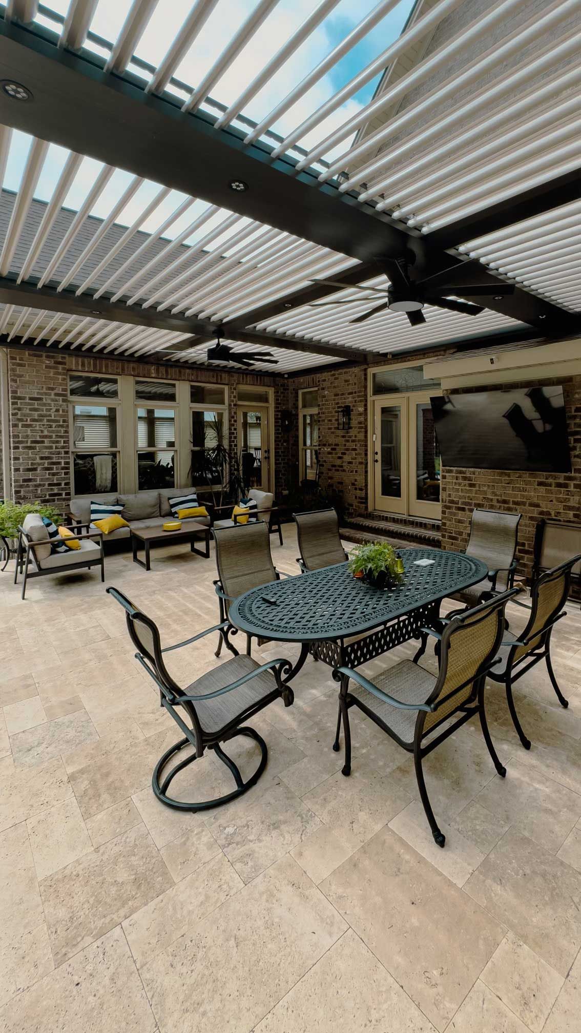 A patio with a table and chairs under a pergola