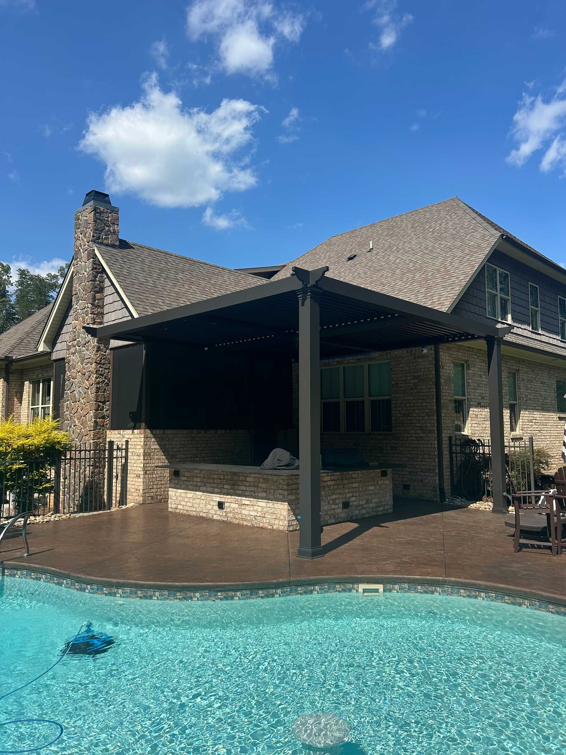 A large house with a swimming pool in front of it