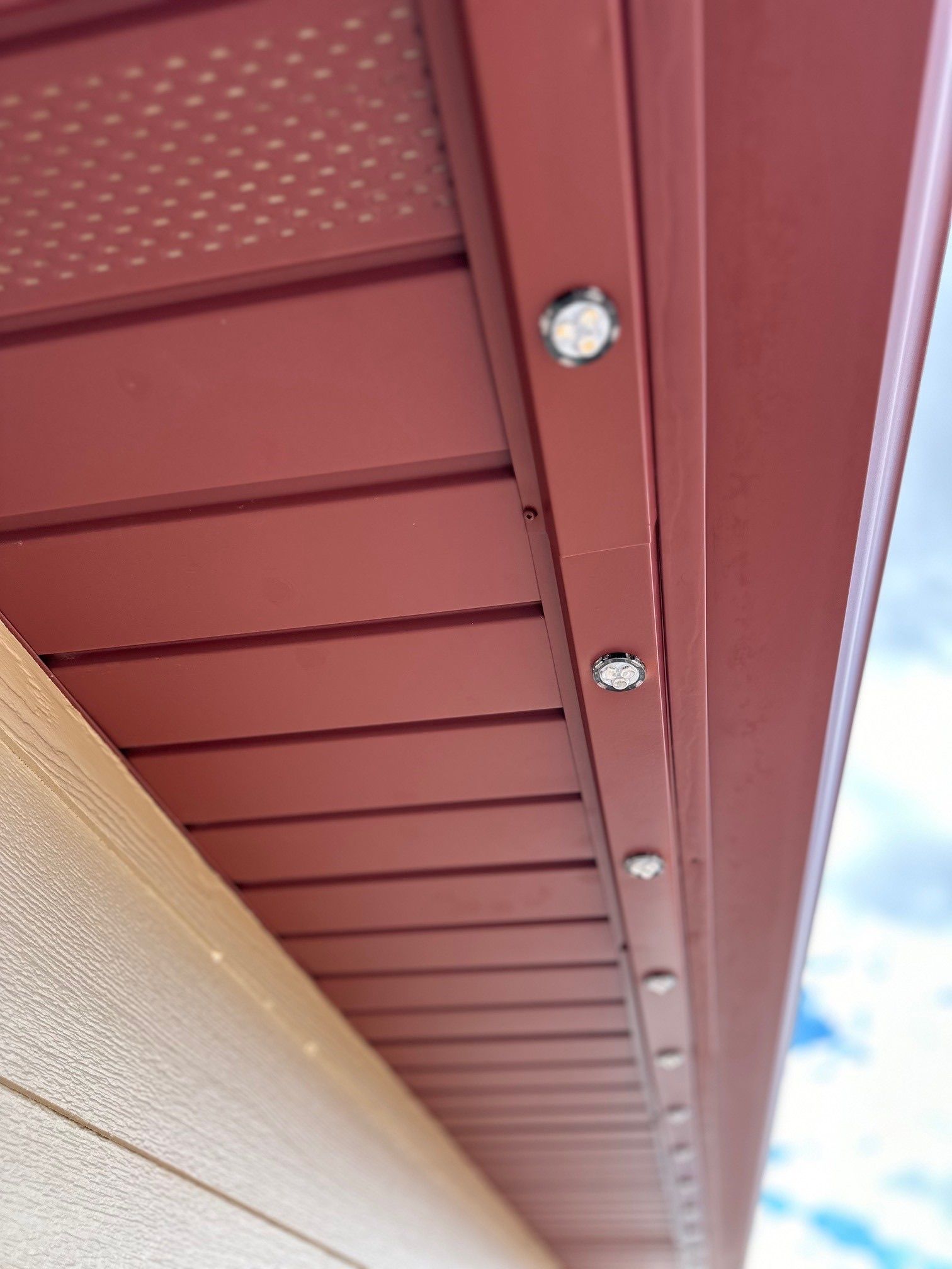 A close up of the ceiling of a building with lights on it.