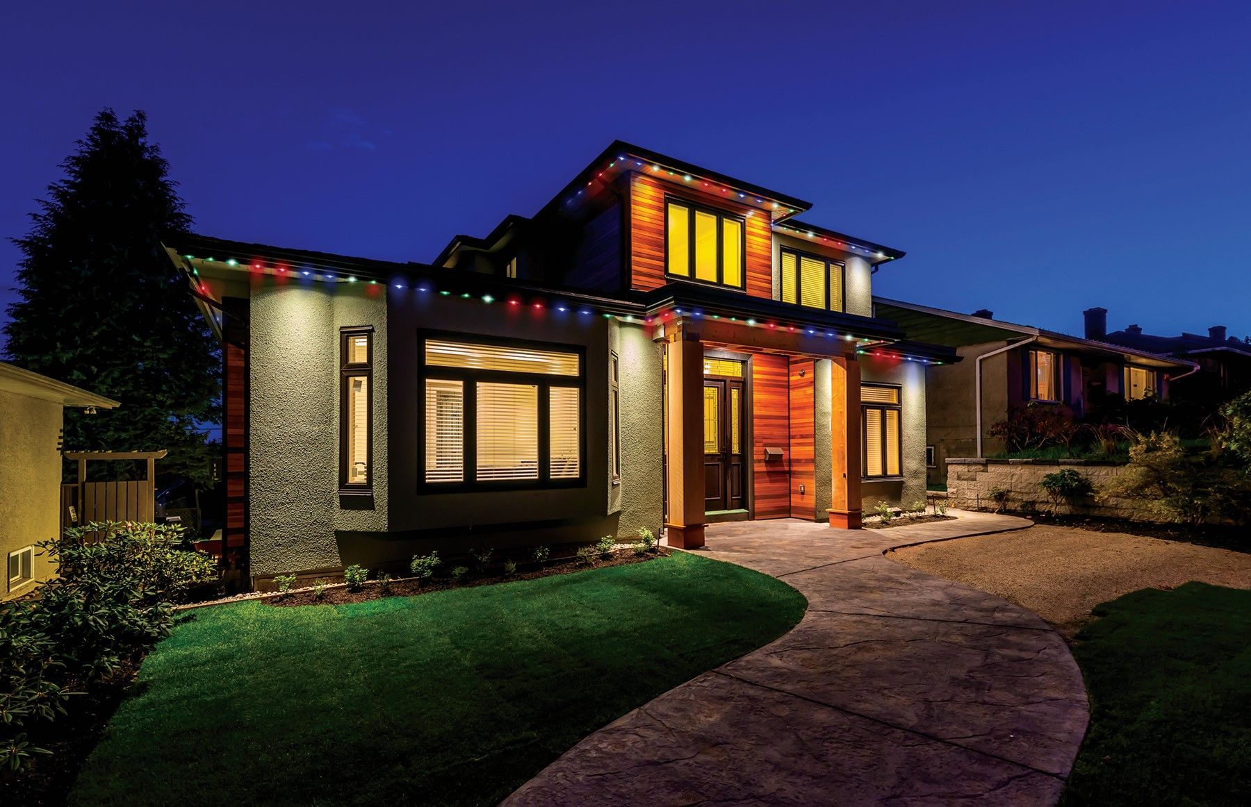 A house with Christmas lights on it is lit up at night