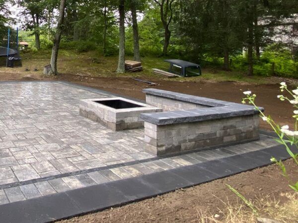 There is a fire pit in the middle of the patio.