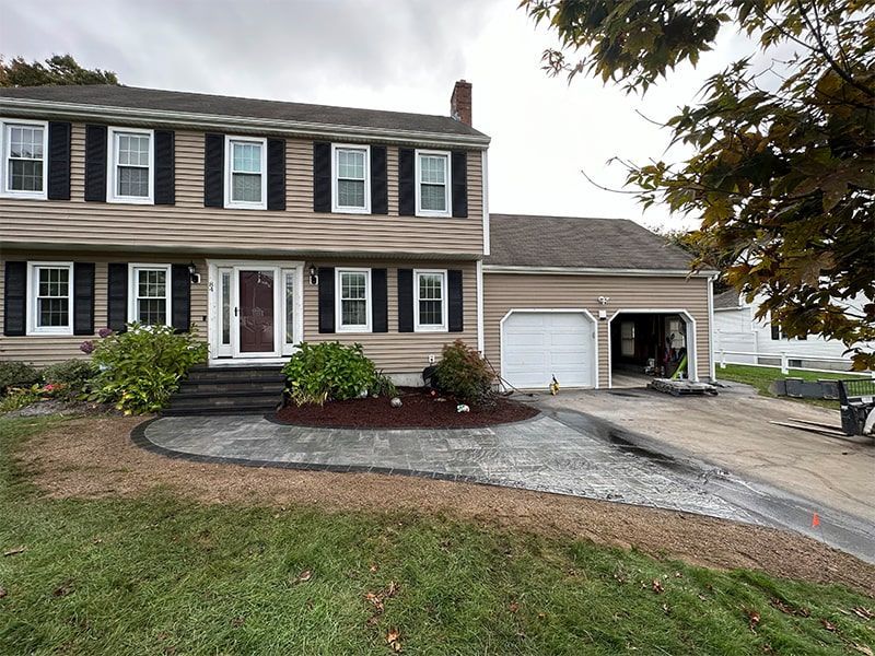 A large house with a driveway in front of it.