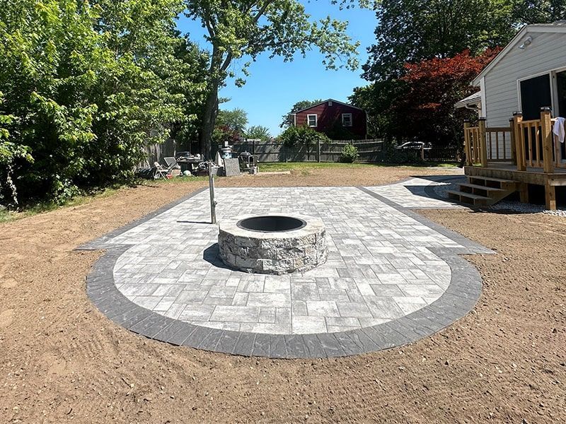There is a fire pit in the middle of the patio.