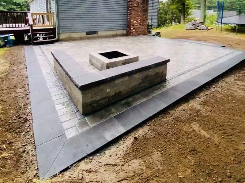 There is a fire pit in the middle of the patio.