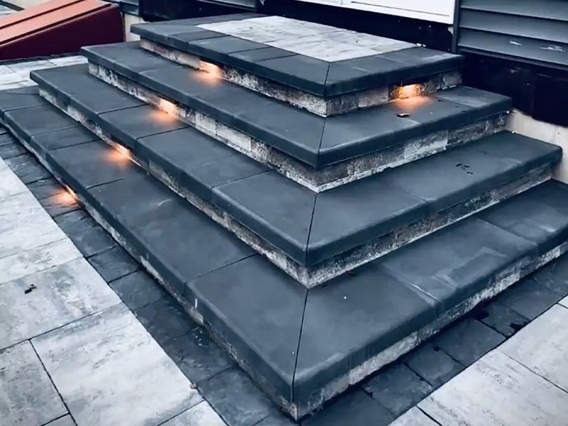 A set of stairs with lights on them are stacked on top of each other.