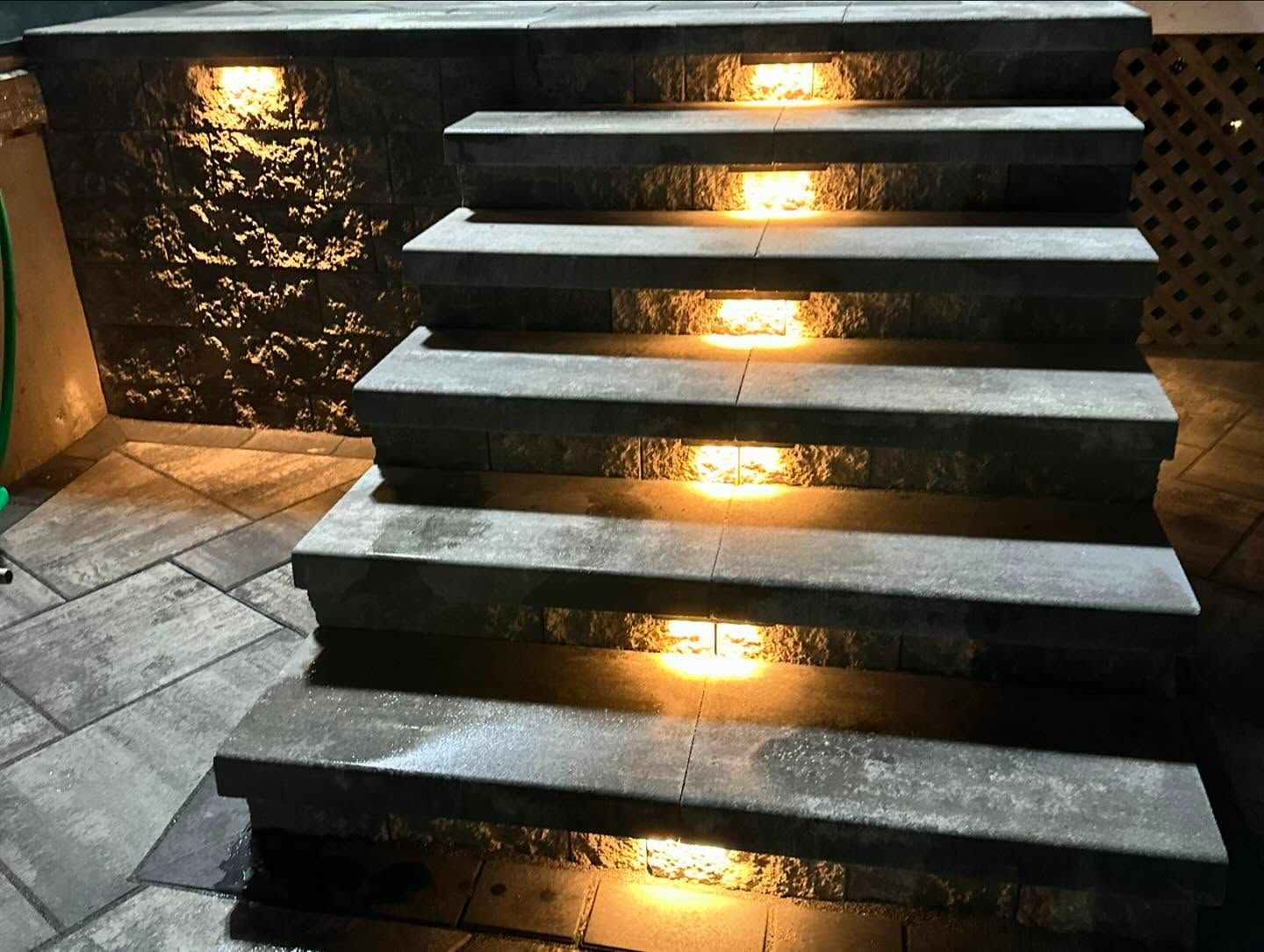 A set of stairs that are lit up at night.
