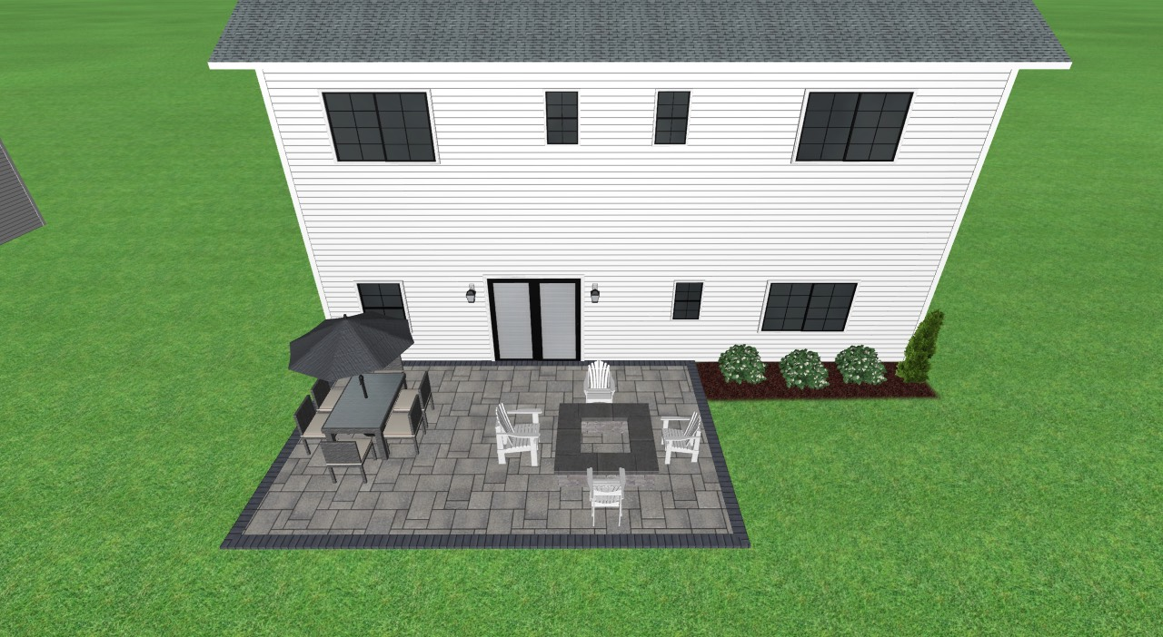Backyard patio with furniture in front of a two-story white house with black shutters.