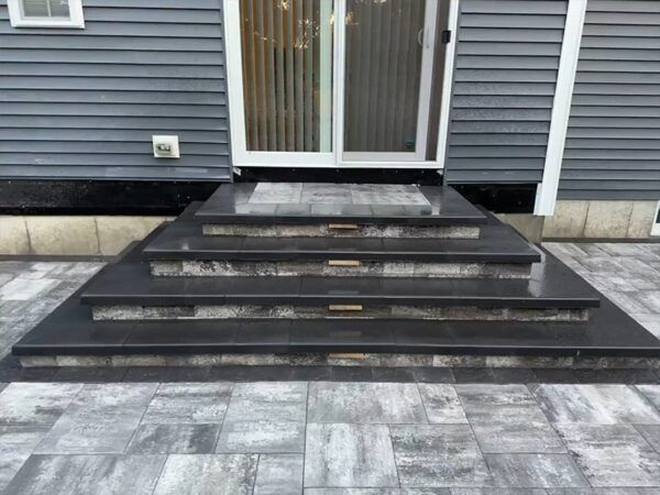 A set of stairs leading up to the front door of a house.
