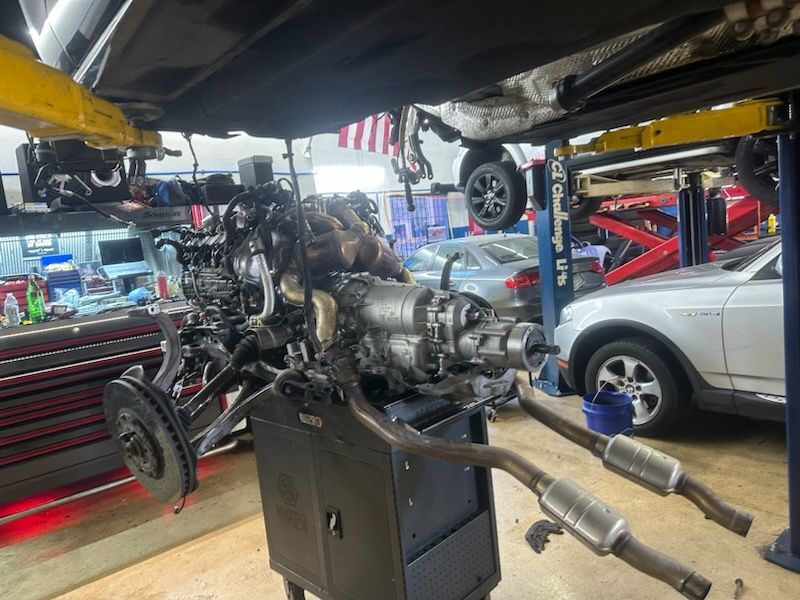 A car engine is being worked on in a garage.