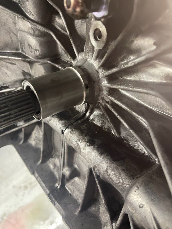 A close up of a metal object with a shaft attached to it.