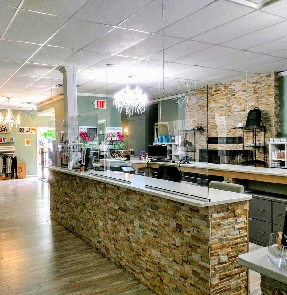 A large room with a long stone counter and a glass wall.