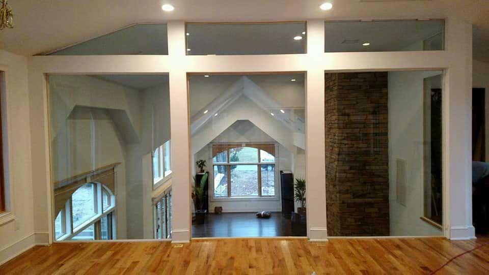 A living room with hardwood floors and lots of windows.