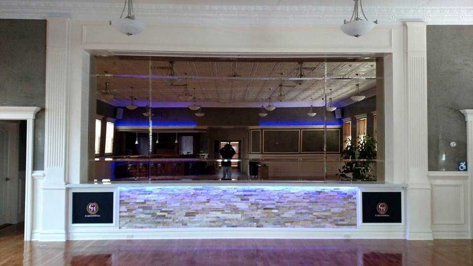 A large room with a bar and a large window.