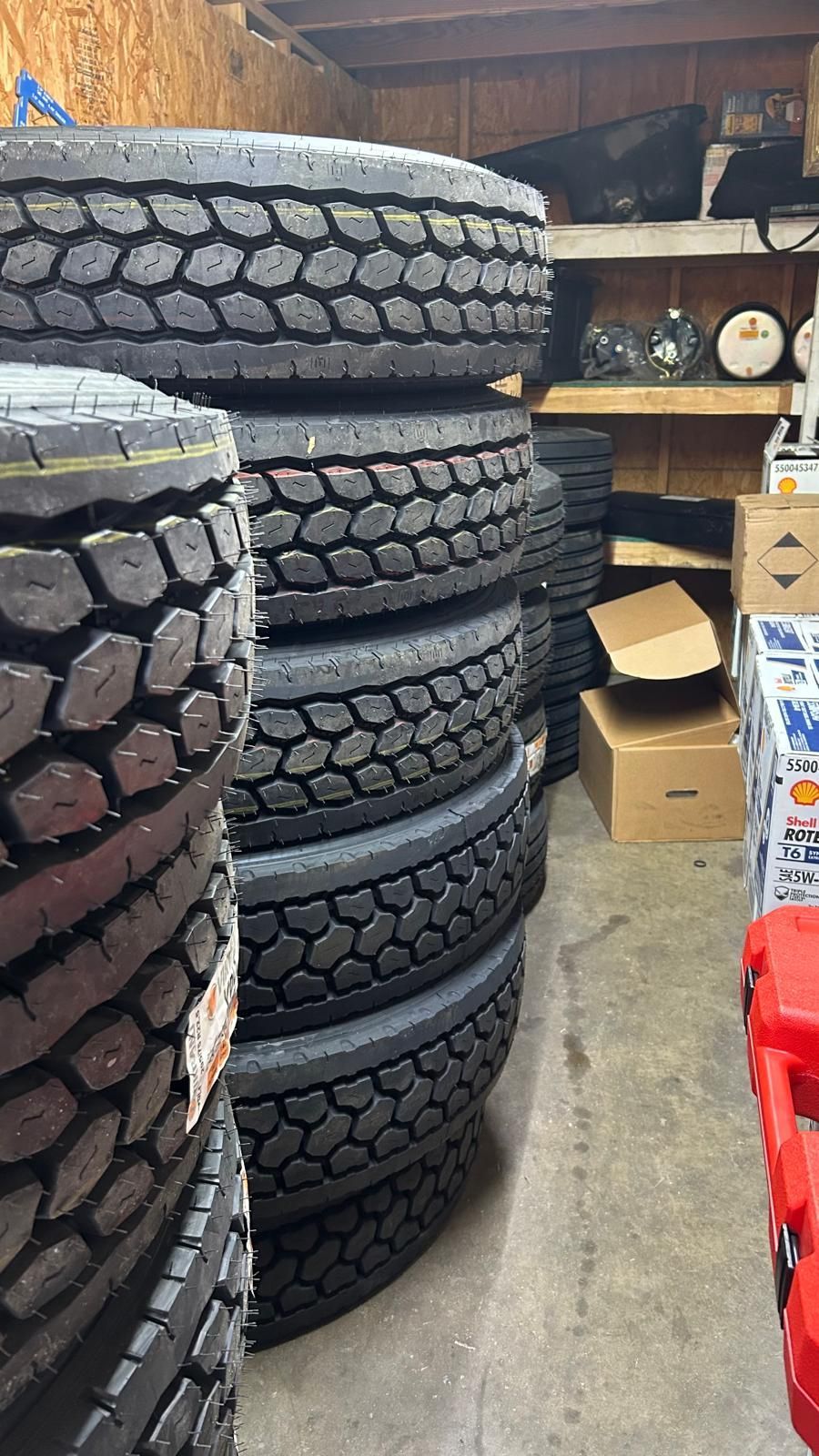 Stacks of black tires inside a storage area.