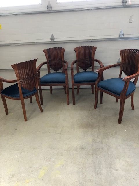 Four chairs are sitting on a concrete floor in a garage.