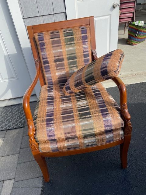 A chair with a pillow on it is sitting in front of a door