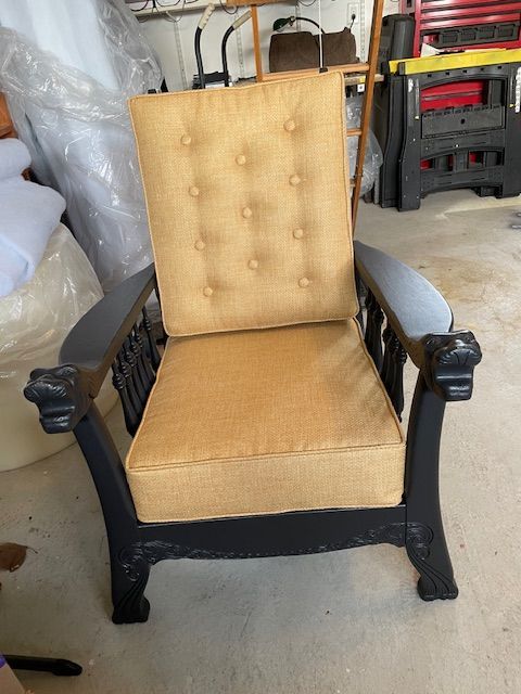 A chair with a yellow cushion sits in a garage