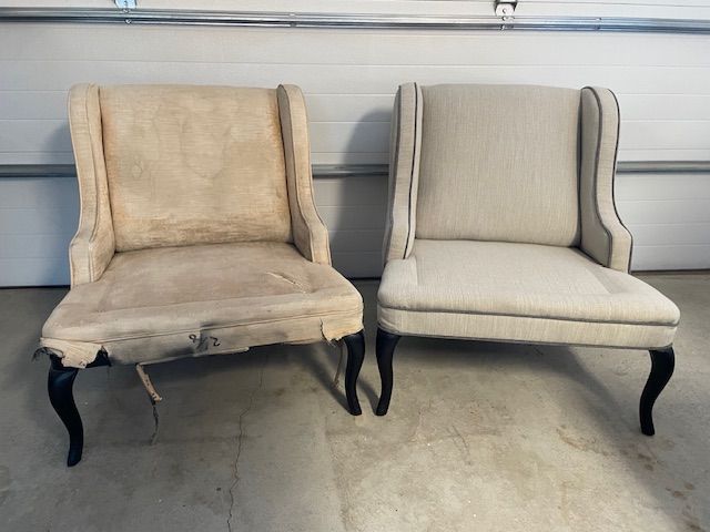 Two chairs are sitting next to each other in a garage.