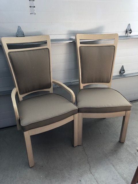 Two chairs in front of a garage door