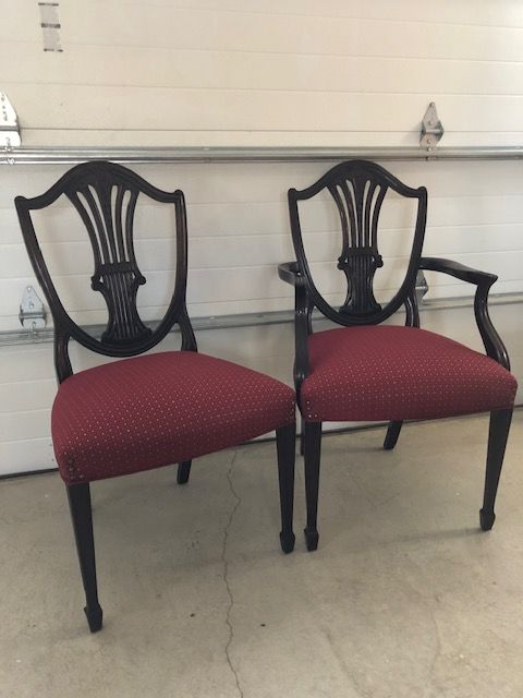 Two chairs are sitting next to each other in front of a garage door.
