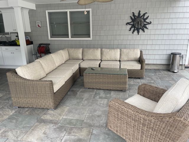 A living room with a sectional couch and chairs