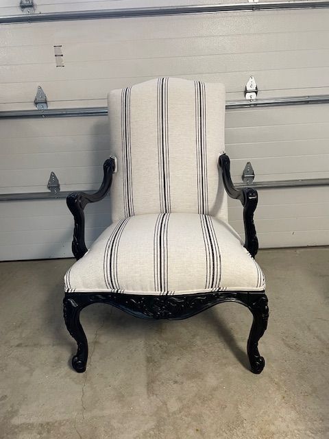 A black and white striped chair is sitting in front of a garage door