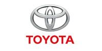Toyota logo with silver emblem above red Toyota wordmark on a white background