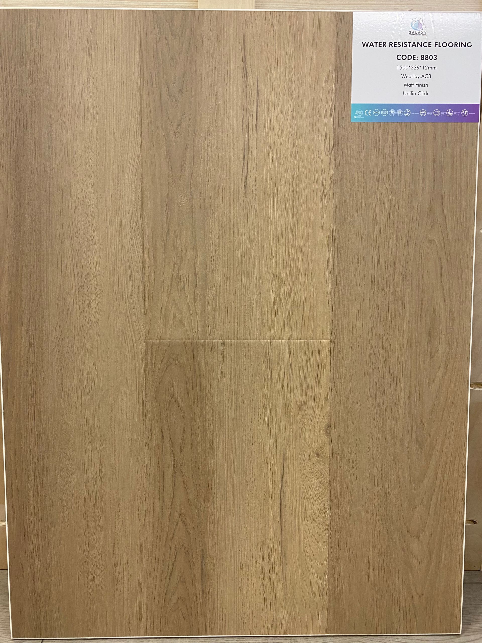 A piece of wood with a label on it is sitting on a table.