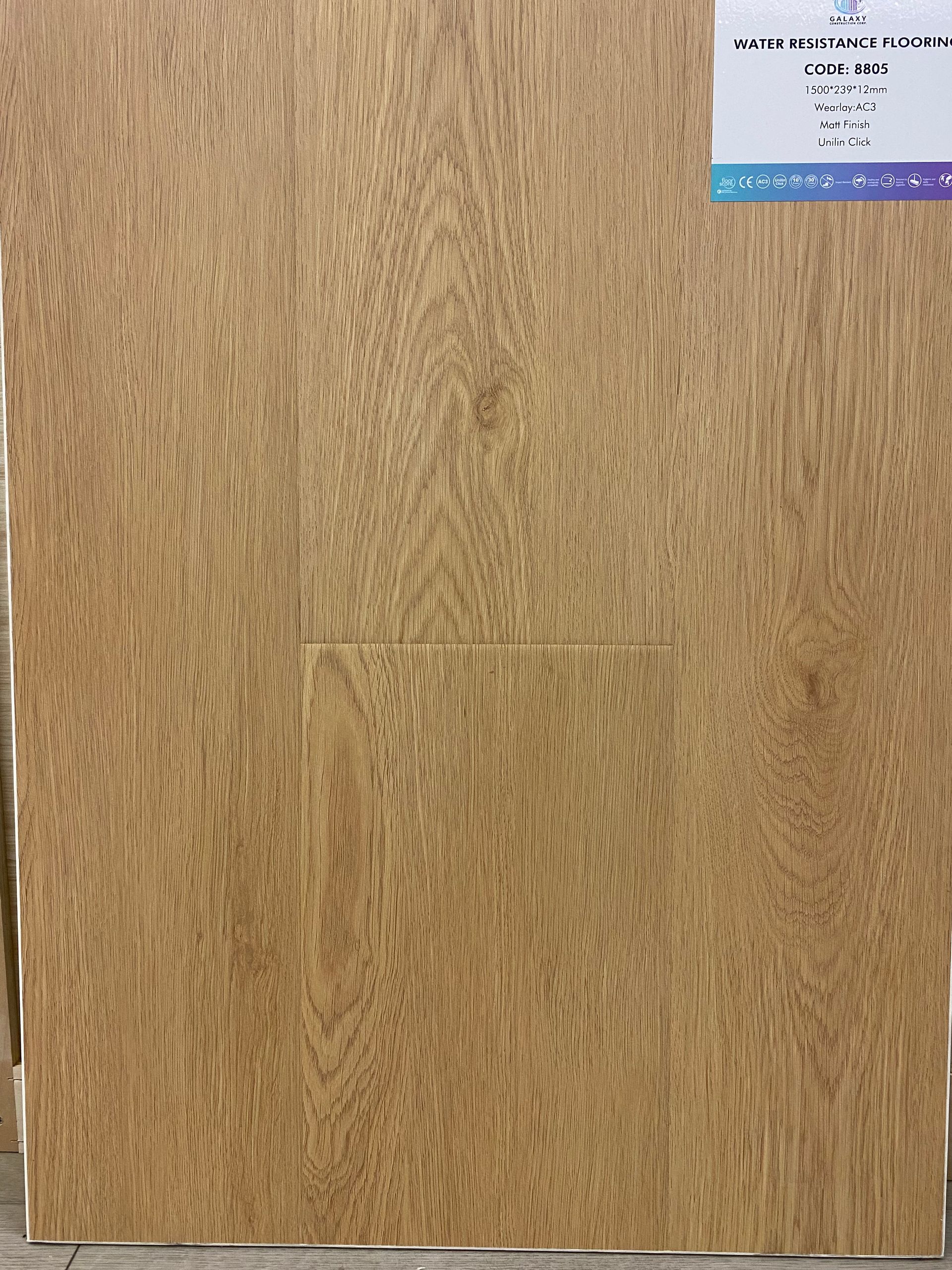 A piece of wood with a label on it is sitting on a table.