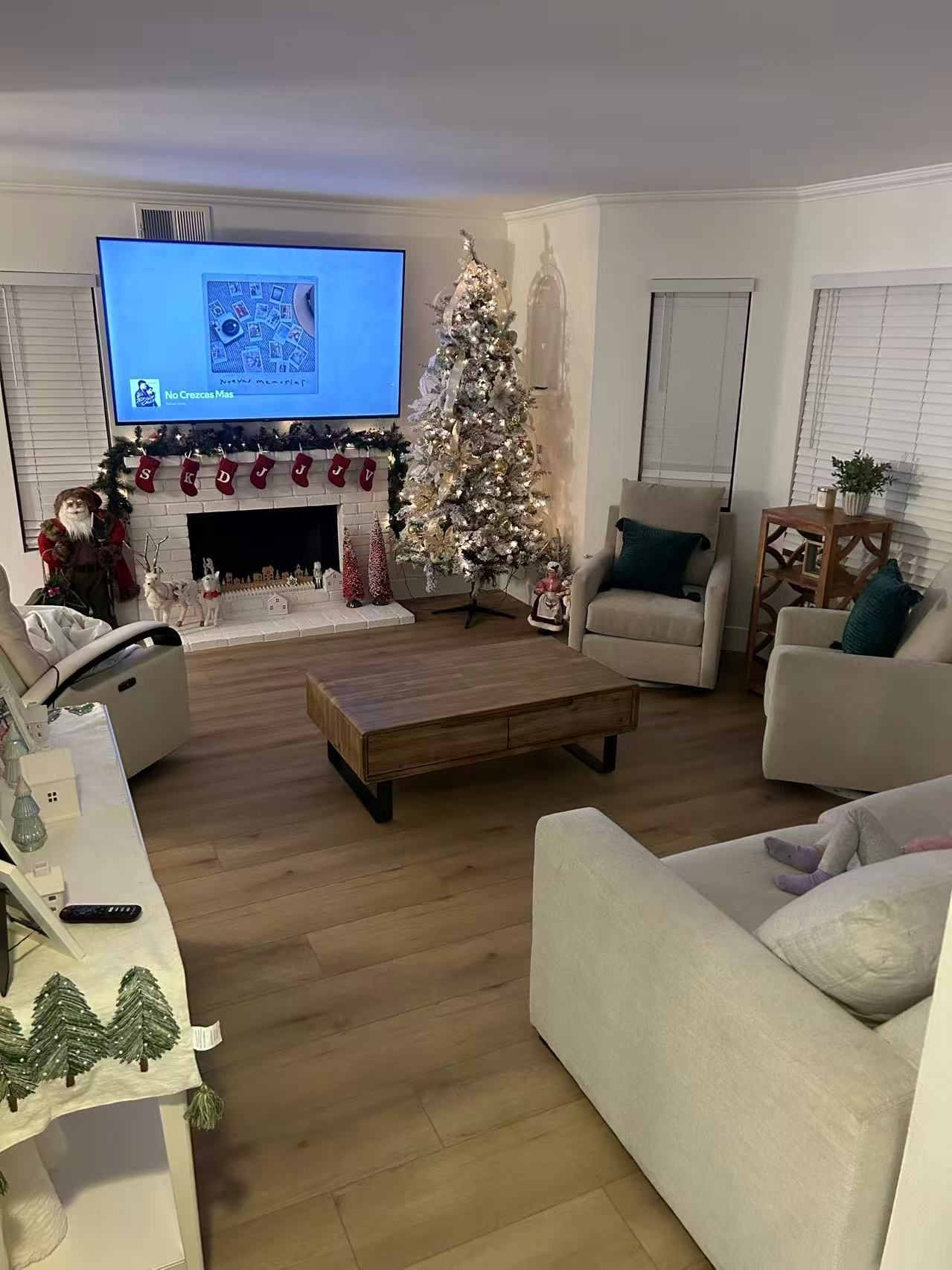 A living room filled with furniture and a christmas tree.