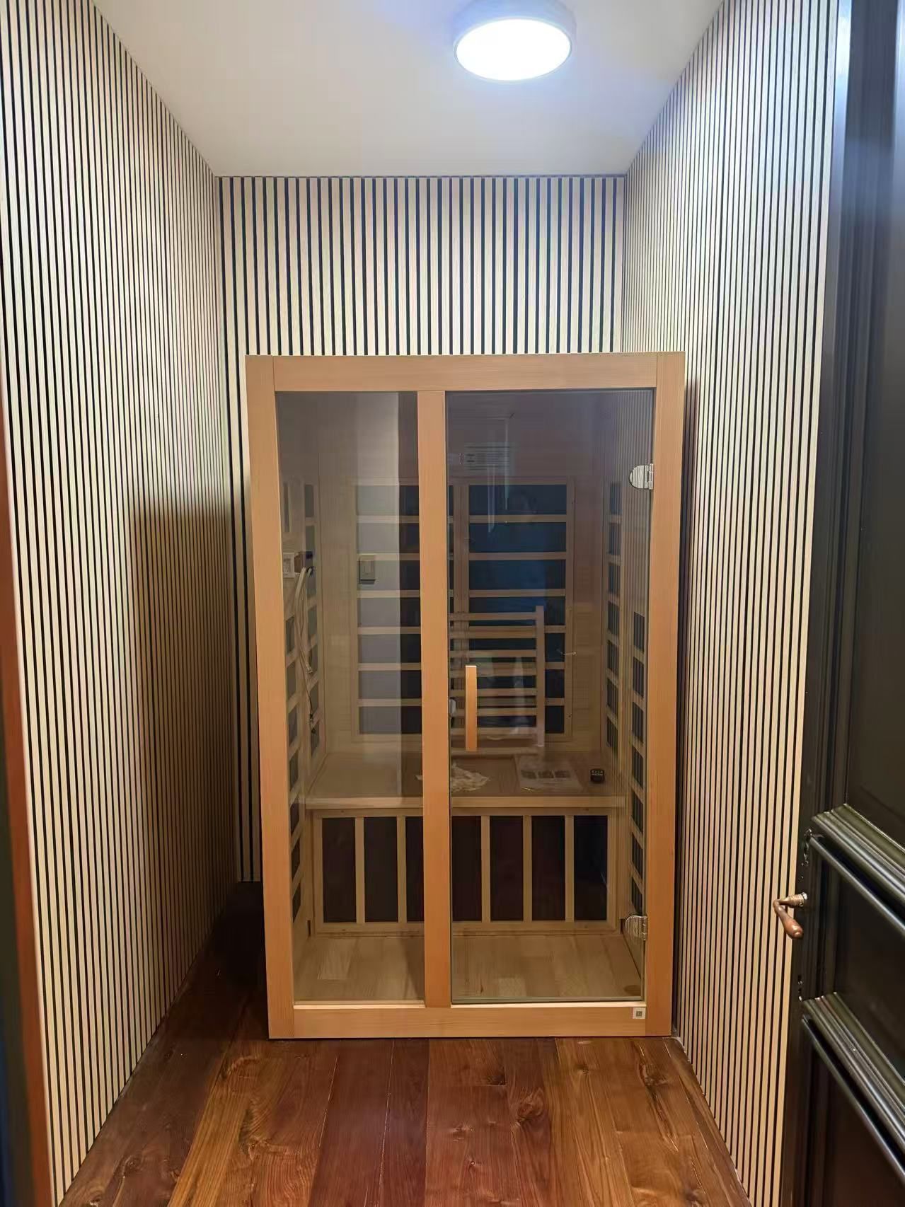 There is a cabinet in the middle of a hallway.