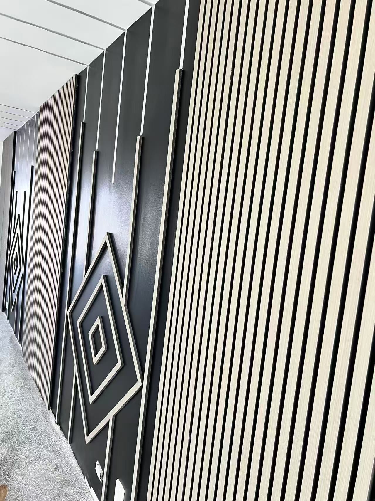 A long hallway with a black and white striped wall.