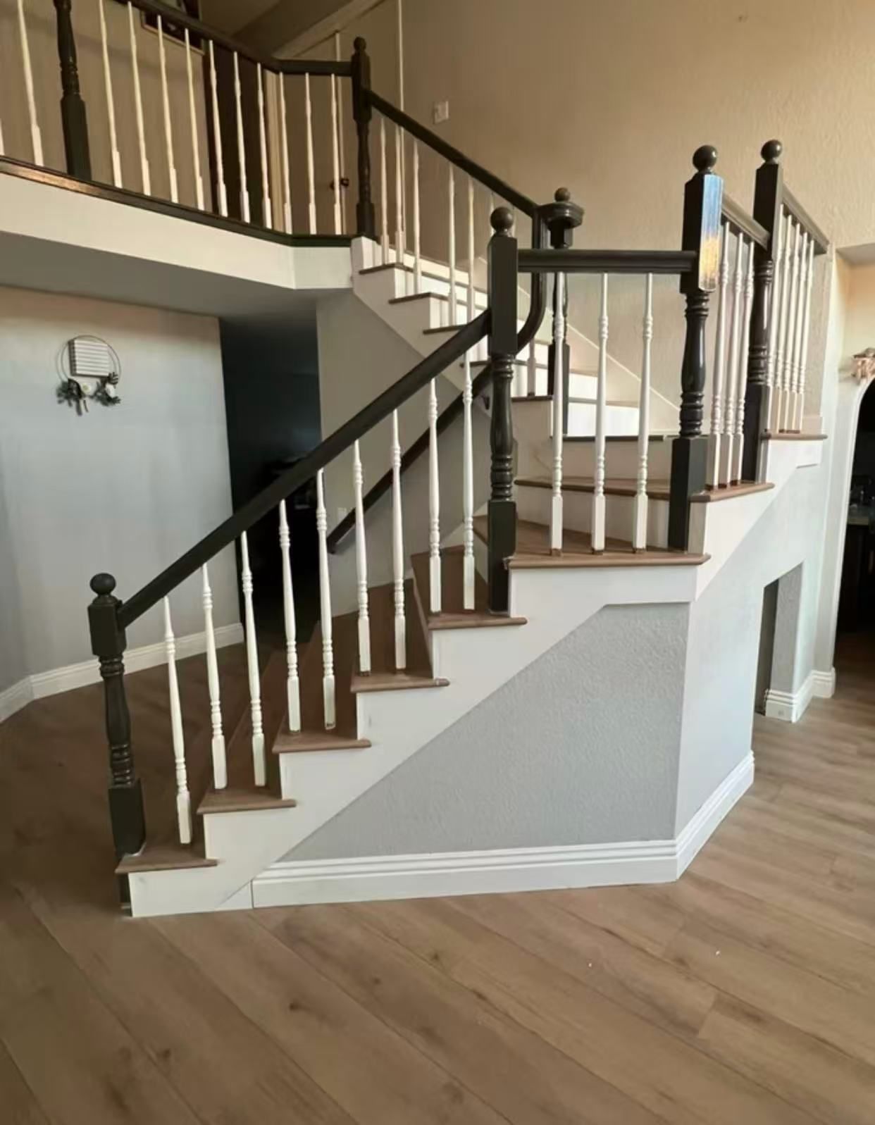 A staircase with a black railing and white steps in a house.