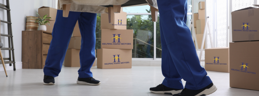 A couple of people standing next to each other in a room filled with cardboard boxes.