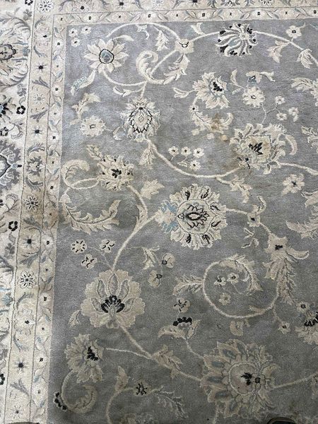 Gray and ivory floral patterned rug.