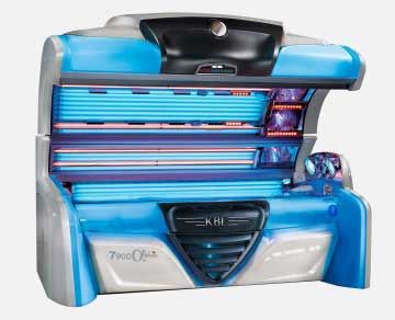 A tanning bed with blue and silver accents. The top is open, revealing rows of ultraviolet lamps.