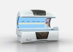 White tanning bed with blue UV lights, a curved top, and a control panel.