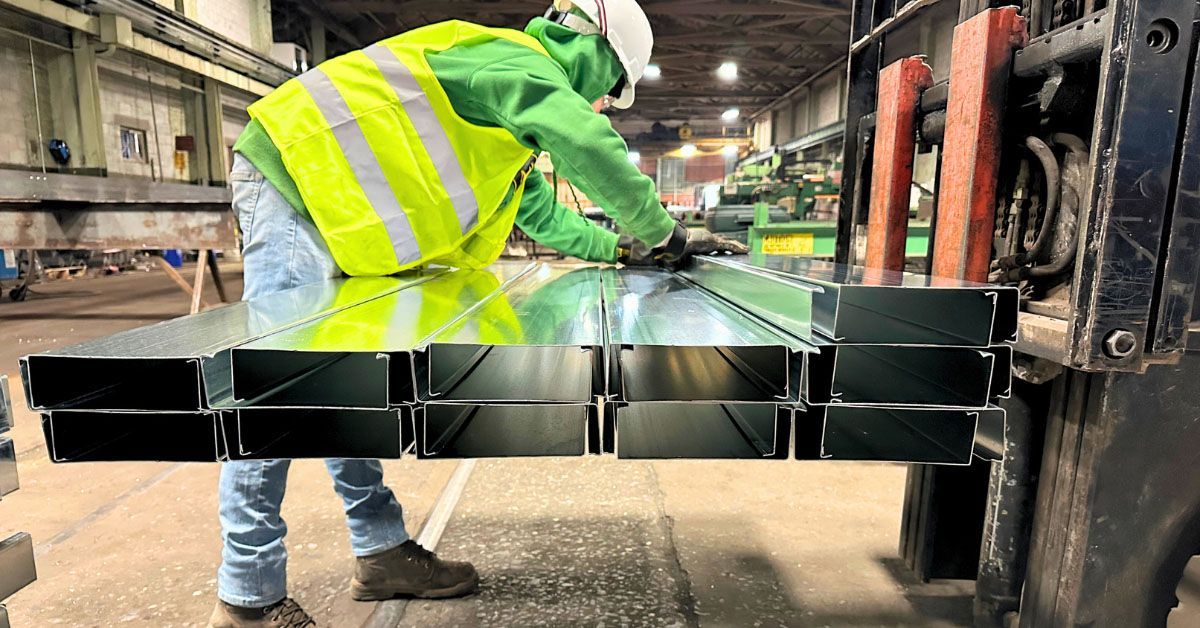 A man carefully loading light gauge frames to a forklift