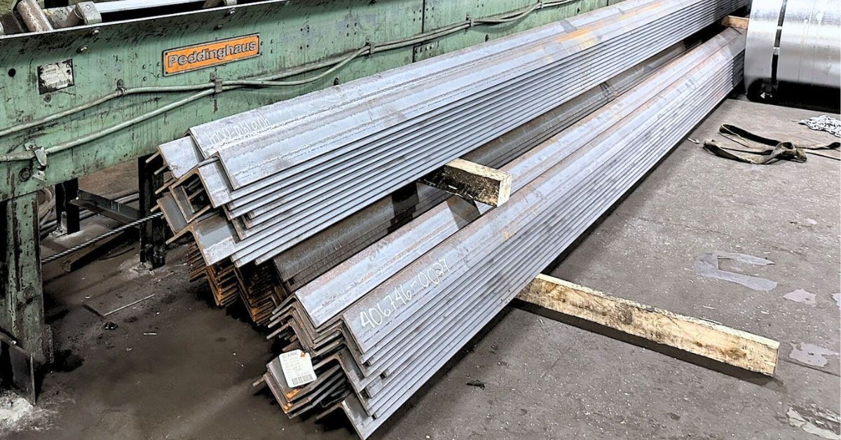 A stack of metal angle bars sitting on top of a wooden pallet