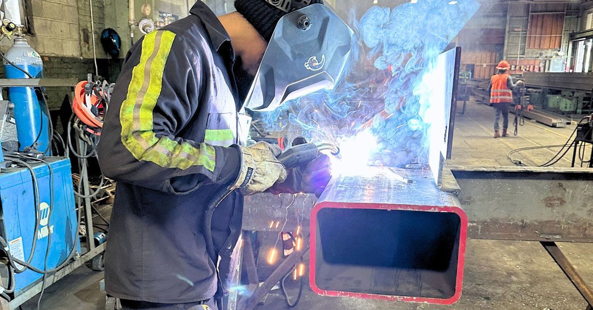 A man is welding a beam