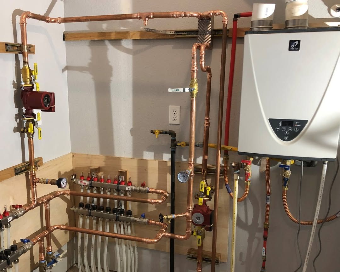 Wall-mounted plumbing and heating system with copper pipes and a white boiler unit.