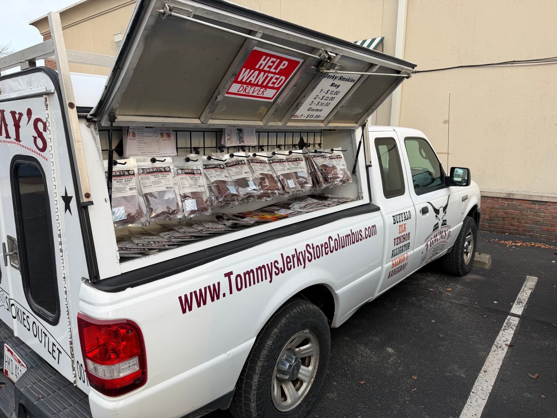 White truck bed open, displaying packaged meat; 